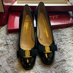 Salvatore Ferragamo classic black patent leather flats with Ferragamo gold bow.
